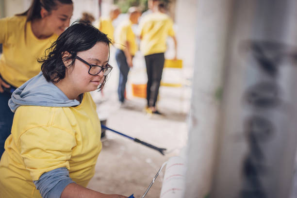 istock Volunteers painting wall together 1887677843