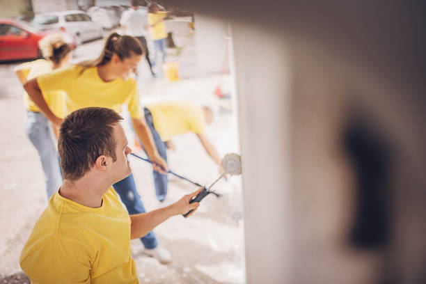 istock Volunteers renovating wall together 1887685539