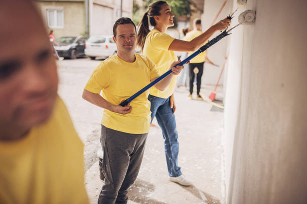 istock Volunteers renovating wall together 1887686559