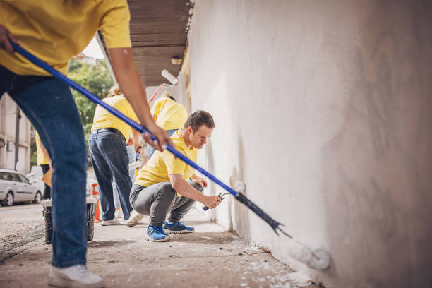 istock Volunteers renovating wall together 1887687082