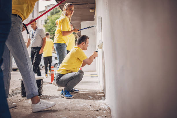 istock Volunteers renovating wall together 1887691720