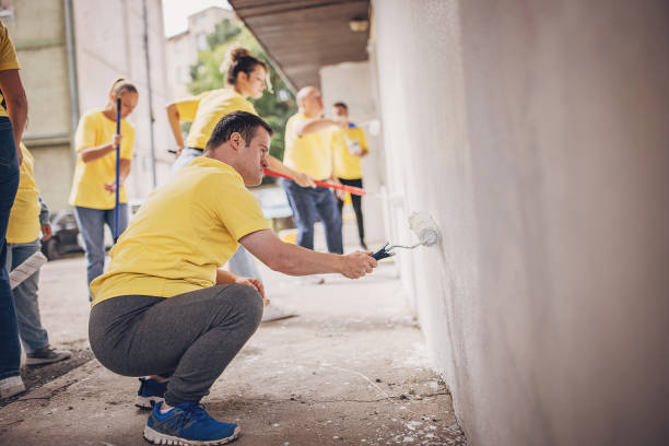 istock Volunteers painting wall together 1887692244