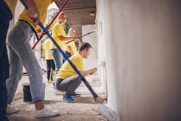istock Volunteers painting wall together 1887692812
