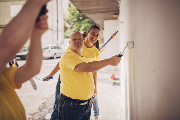 istock Volunteers renovating wall together 1887697411