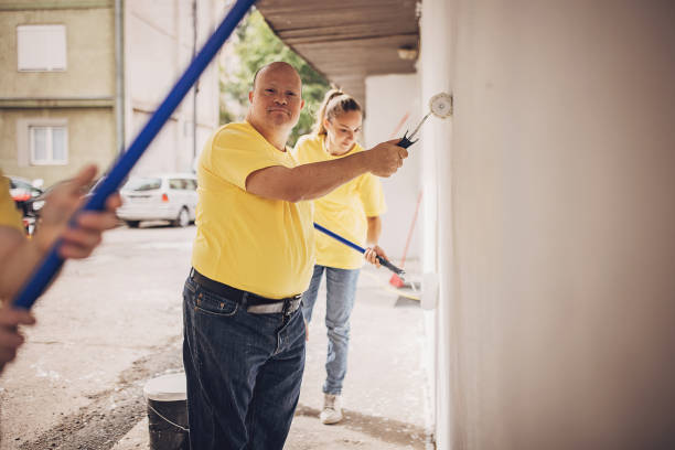 istock Volunteers renovating wall together 1887698438