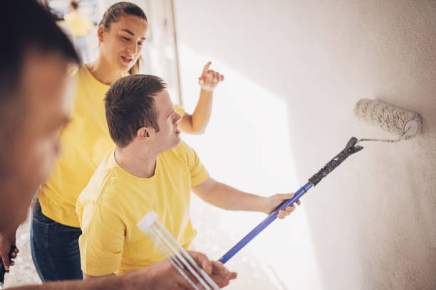 istock Volunteers painting wall 1887699979