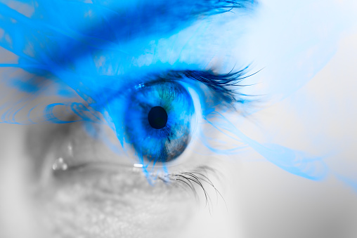 Macro photography of human eye with superimposed effect in blue color - Abstract image reflecting futuristic and cutting-edge technology.