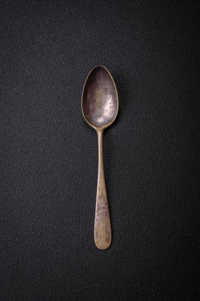 istock Empty metal spoon on dark textured concrete background 1887718890