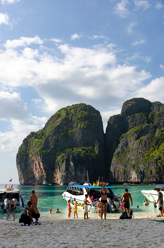 3rd March, 2017 - Maya Bay, Thailand: The white sands of Maya Bay are dotted with tourists, a testament to the enduring appeal of Thailand's natural wonders. The iconic limestone cliffs rise majestically in the background, embracing the bay that became famous through film and continues to captivate visitors from around the world.