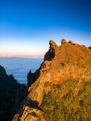 Pico do Arieiro, Madeira, Portugal. Sunset over the clouds, high mountains, walking over the clouds