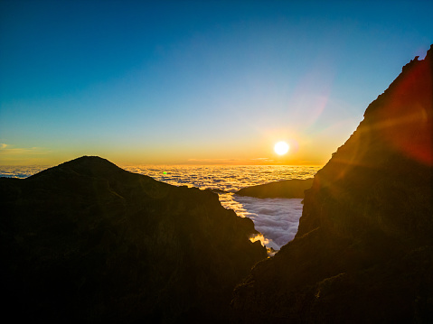 Pico do Arieiro, Madeira, Portugal. Sunset over the clouds, high mountains, walking over the clouds