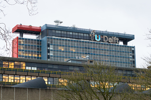 Delft, Netherlands - December 2023: Building with logo of the Technical University (TU) of Delft, The Netherlands.
