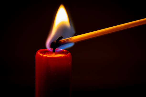 A red candle is illuminated