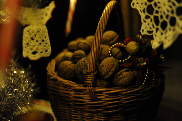 Christmas bucket with walnuts near decorations.