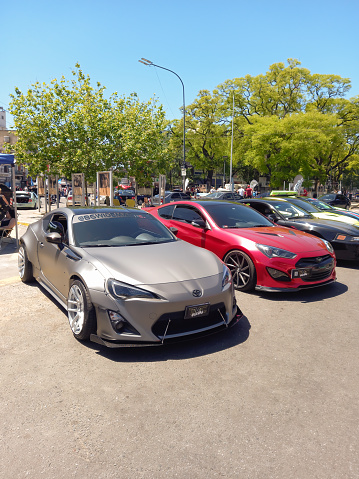Buenos Aires, Argentina - Nov 6, 2022: Gray sport Toyota 86 GT coupe parked in the the side of a treelined street at a classic car show. Sunny day. Copy space