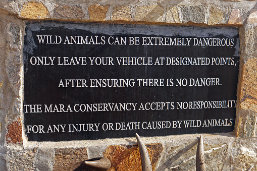 Narok, Kenya - July 12, 2017: Warning sign wild animals danger in Mara conservancy Narok county Kenya Africa.