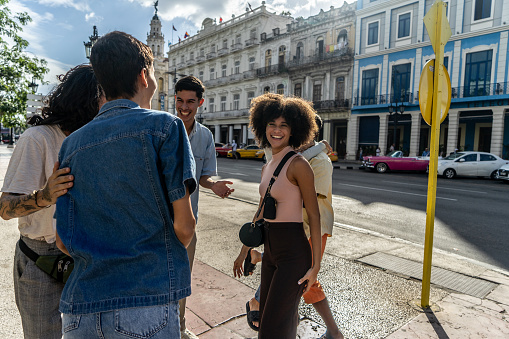 Young man talking with his friends on the street