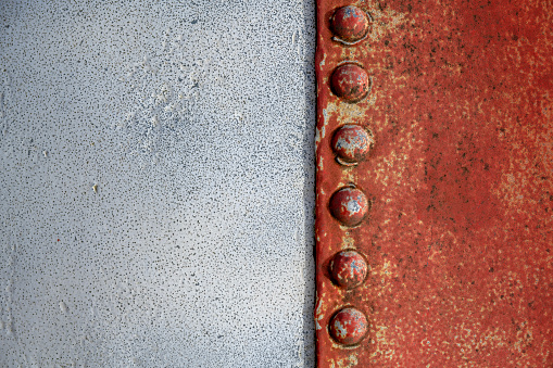 Rusty weathered backgrounds with rivets riveted together hull of an old boat