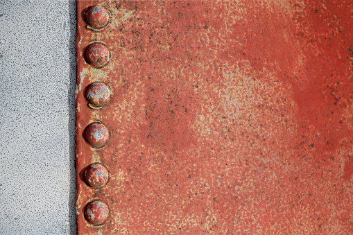 Rusty weathered backgrounds with rivets riveted together hull of an old boat