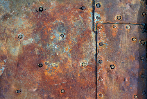 Rusty weathered backgrounds with rivets riveted together hull of an old boat