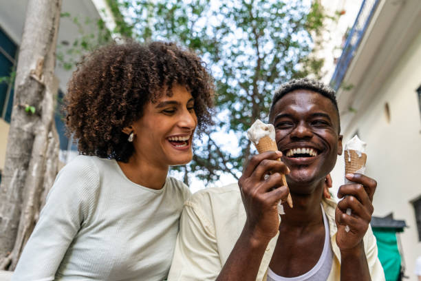 istock Couple having fun while eating ice cream outdoors 1887949400