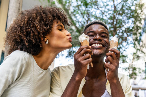 istock Couple having fun while eating ice cream outdoors 1887949407