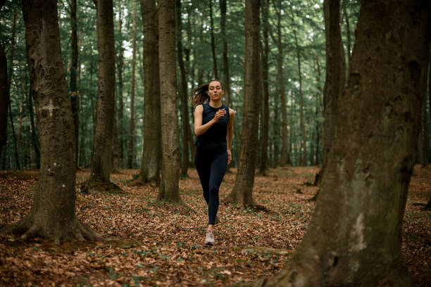 istock Young female athlete runs every day in forest, preparing for marathon 1887951992