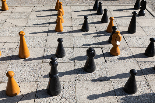 Giant chess set and figures in a city square