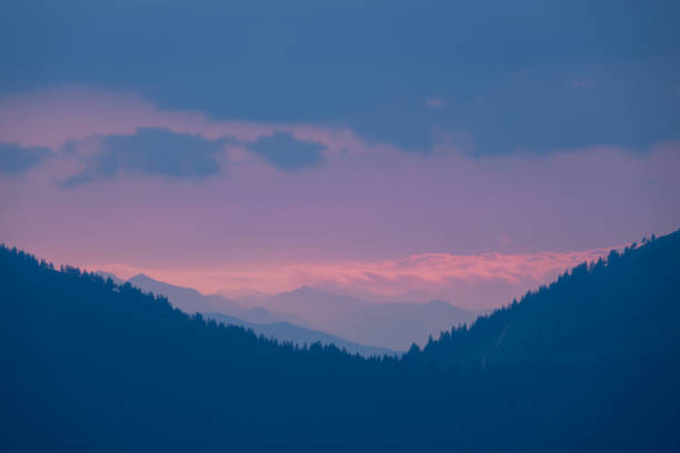istock SILHOUETTE: Beautiful layered mountain landscape with colorful clouds at sunset 1888054231