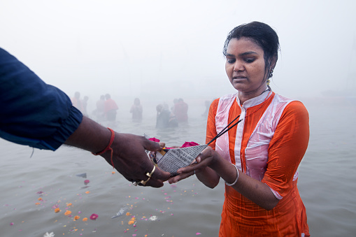 Hallahabad. India- january 17 2019: The Prayag Kumbh Mela, also known as Allahabad Kumbh Mela is a mela, or religious gathering, associated with Hinduism and held in the city of Prayagraj, India, at the Triveni Sangam, the confluence of the Ganges, the Yamuna, and the mythical Sarasvati river.The festival is marked by a ritual dip in the waters, but it is also a celebration of community commerce with numerous fairs, education, religious discourses by saints, mass feedings of monks or the poor, and entertainment spectacle.Approximately 50 and 30 million people attended the Allahabad Ardh Kumbh Mela in 2019 and Maha Kumbh Mela in 2013 respectively to bathe in the holy river Ganges, making them the largest peaceful gathering events in the world.