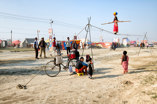 Hallahabad. India- january 14 2019: The Prayag Kumbh Mela, also known as Allahabad Kumbh Mela is a mela, or religious gathering, associated with Hinduism and held in the city of Prayagraj, India, at the Triveni Sangam, the confluence of the Ganges, the Yamuna, and the mythical Sarasvati river.[1] The festival is marked by a ritual dip in the waters, but it is also a celebration of community commerce with numerous fairs, education, religious discourses by saints, mass feedings of monks or the poor, and entertainment spectacle.[2][3] Approximately 50 and 30 million people attended the Allahabad Ardh Kumbh Mela in 2019 and Maha Kumbh Mela in 2013 respectively to bathe in the holy river Ganges, making them the largest peaceful gathering events in the world.[4][5]