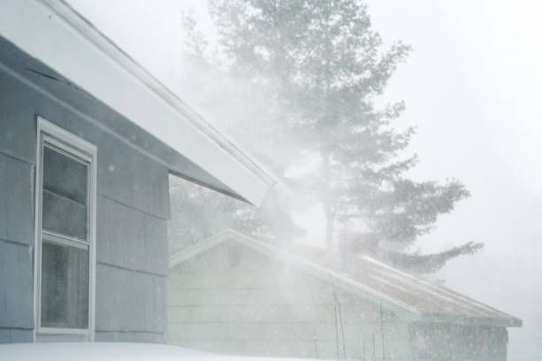 istock strong wind blowing snow off the roof in blizzard 1888072338
