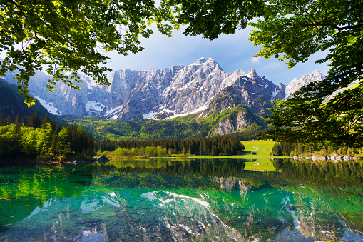 Mountain Range and the peak of the Mount Mangart (2677 m) seen from Fusine Lake, Julian Alps, Tarvisio, Udine, Friuli Venezia Giulia, Italy Slovenia border, Europe