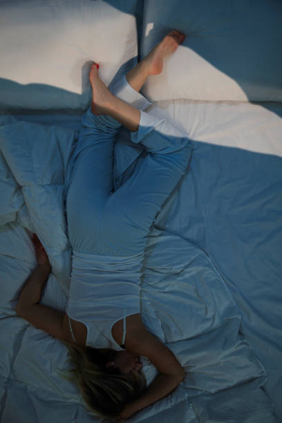 istock The young woman is sleeping upside down in her bed. 1888101292