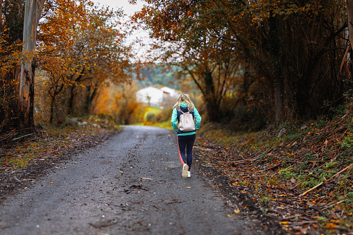 Woman hiker on a hike in autumn