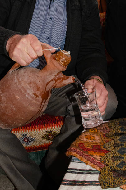 In Turkey, a man who fills water from a jug into a glass.