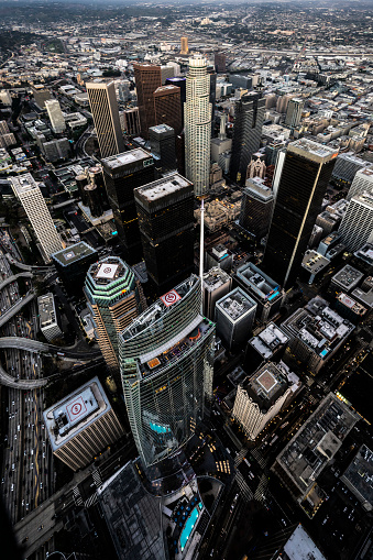 Grandiose architecture of the Los Angeles downtown with its skyscrapers captured from a helicopter after sunset.