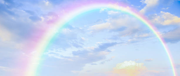 istock Beautiful rainbow with clouds and blue sky 1888325289