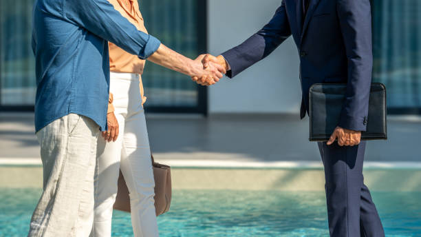 istock Real estate agent and buyer handshake 1888325301