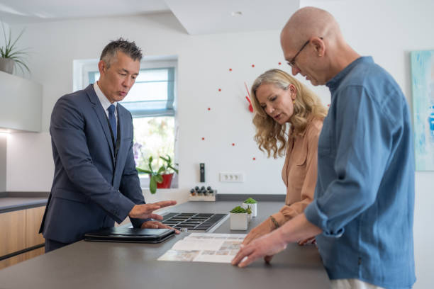 istock Couple checking real estate catalog 1888325500