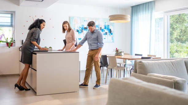istock Real estate agent showing kitchen to couple 1888325808