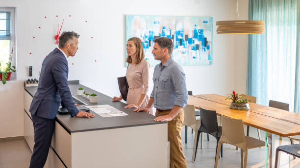 istock Couple chatting at real estate showing 1888325815