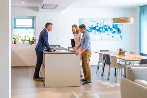 istock Couple chatting at real estate showing 1888325816