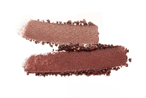 Cosmetic brown chocolate smeared eye shadow swatch isolated on white background
