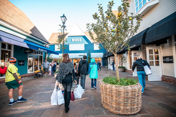 Bicester Village outlets, London - 14 October 2023 : Tourists visiting and shopping in one of UK largest outlets - Bicester village stock photo