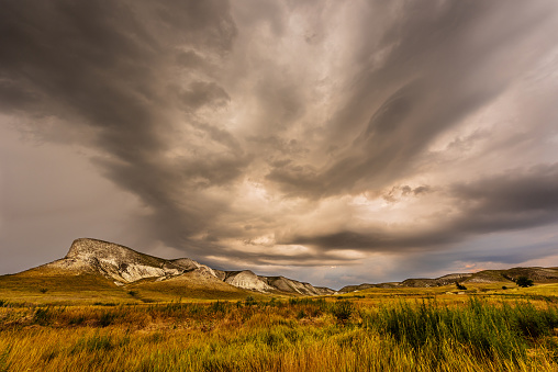Dark stormy sky. Storm clouds. Dramatic sky over mountain landscape. Rain and hail on the hills. Panorama natural background.