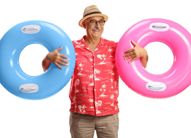 istock Mature man holding two swimming rings and smiling 1888447956