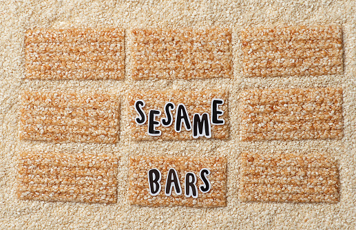 Sesame seeds and sesame protein sweet energy bars pattern. With an inscription sesame bars