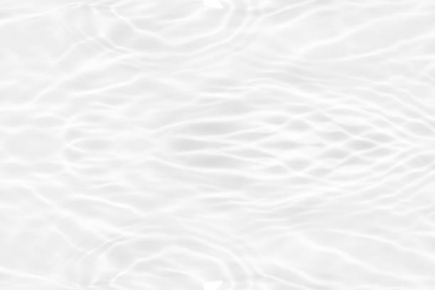 istock White water with ripples on the surface. Defocus blurred transparent white colored clear calm water surface texture with splashes and bubbles. Water waves with shining pattern texture background. 1888574189