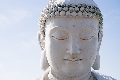 Huge Buddha statue crying under the blue sky